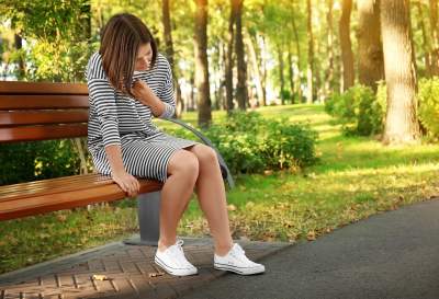 Woman at park worried she is having heart attack with pain from anxiety